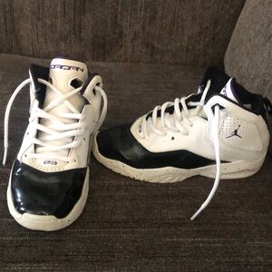 Black white with a little bit of purple Jordan 11s kids